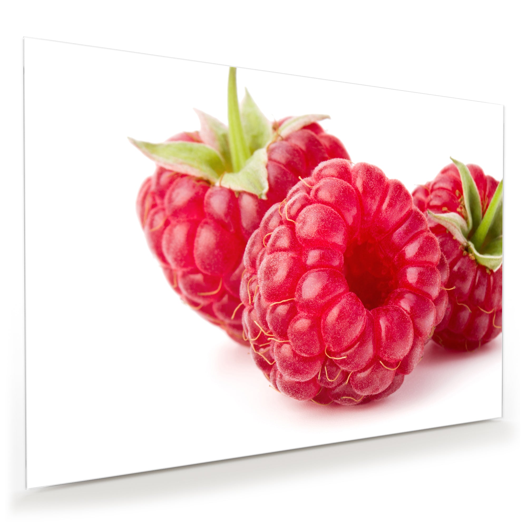 Wandbild - Drei Himbeeren mit Blatt