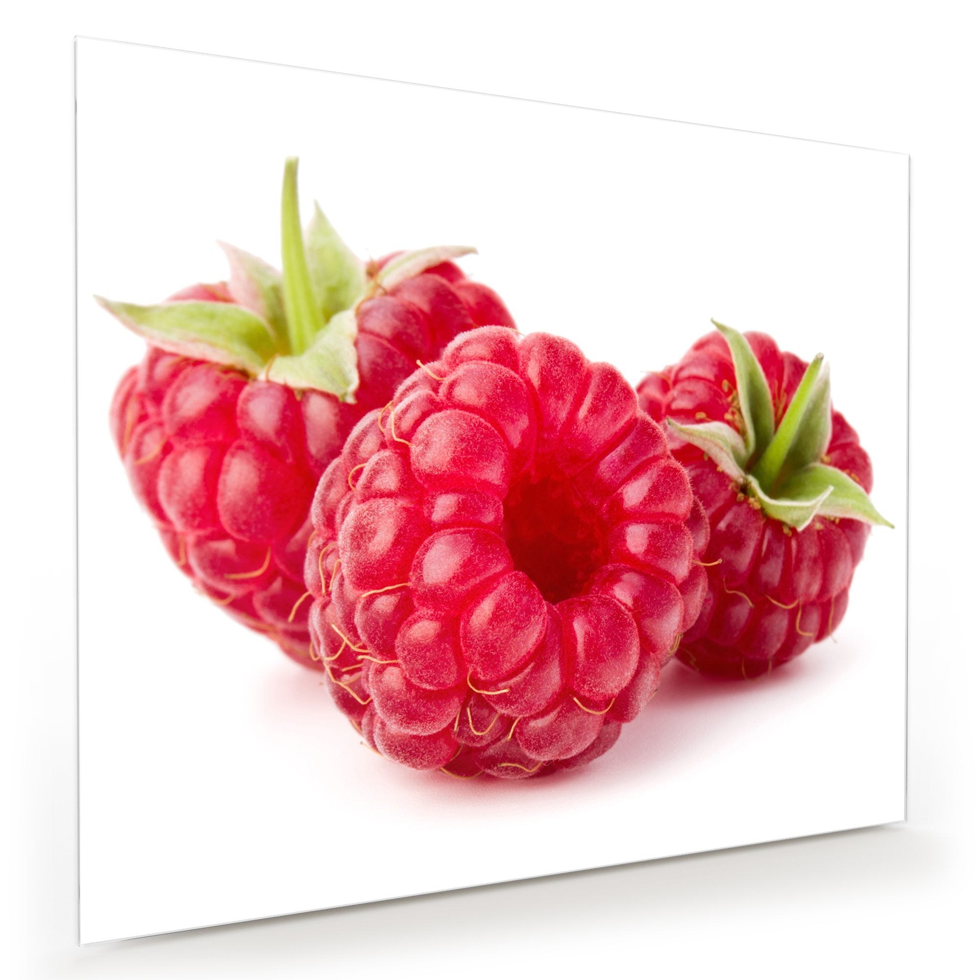 Wandbild - Drei Himbeeren mit Blatt